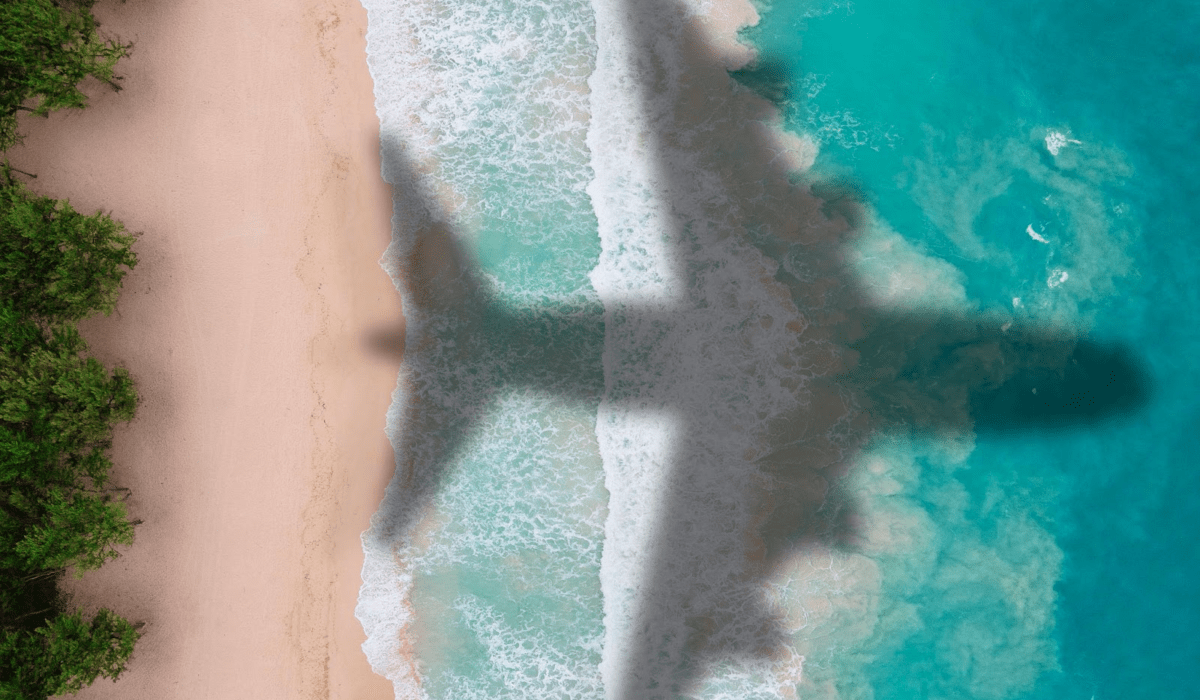 A plane flies over an Indonesian beach