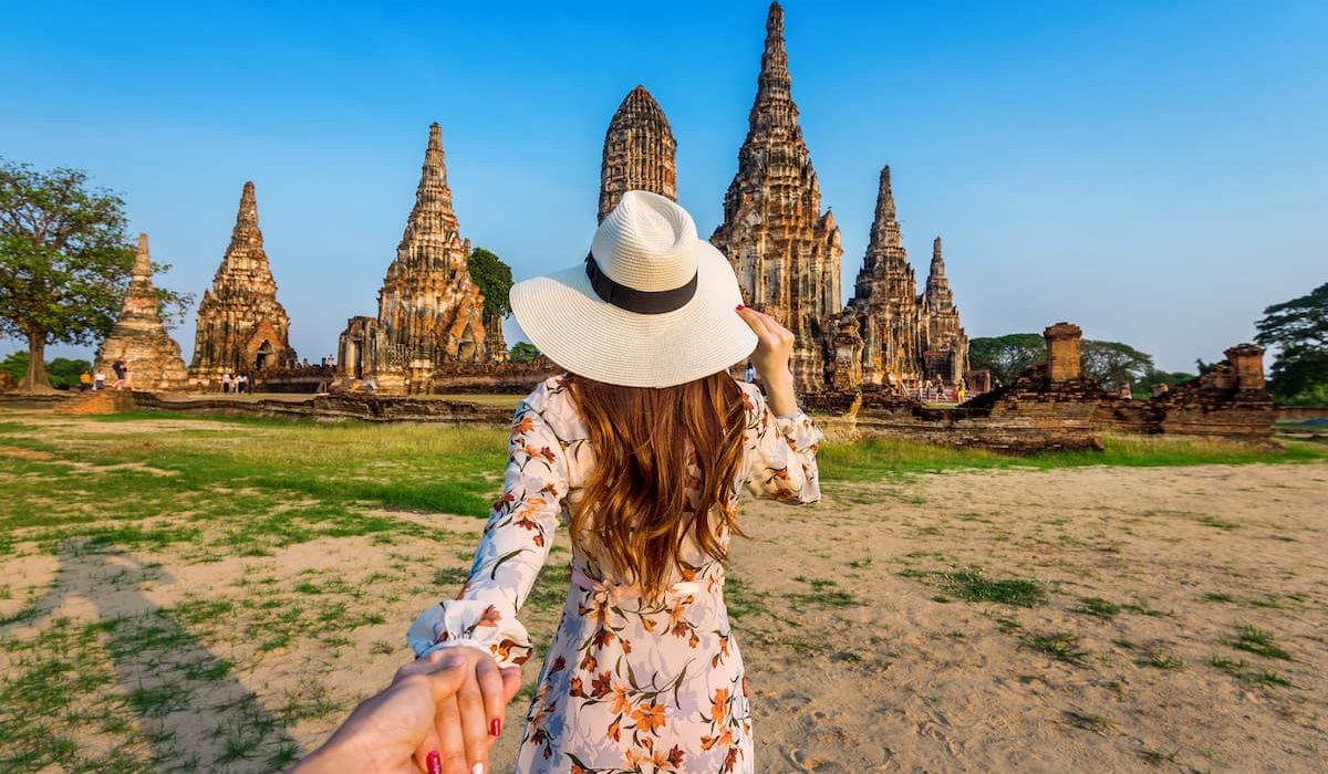 A girl looks at ancient temples in Thailand