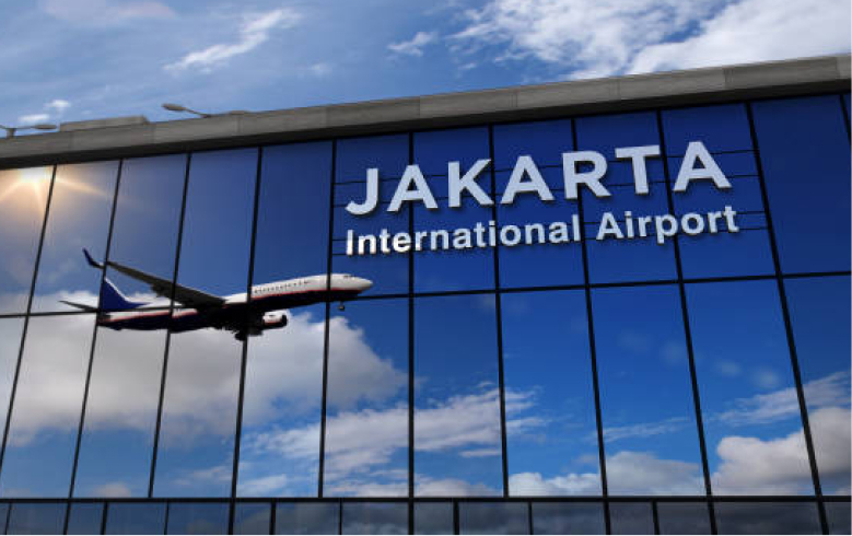 The plane is reflected in the windows of Jakarta airport