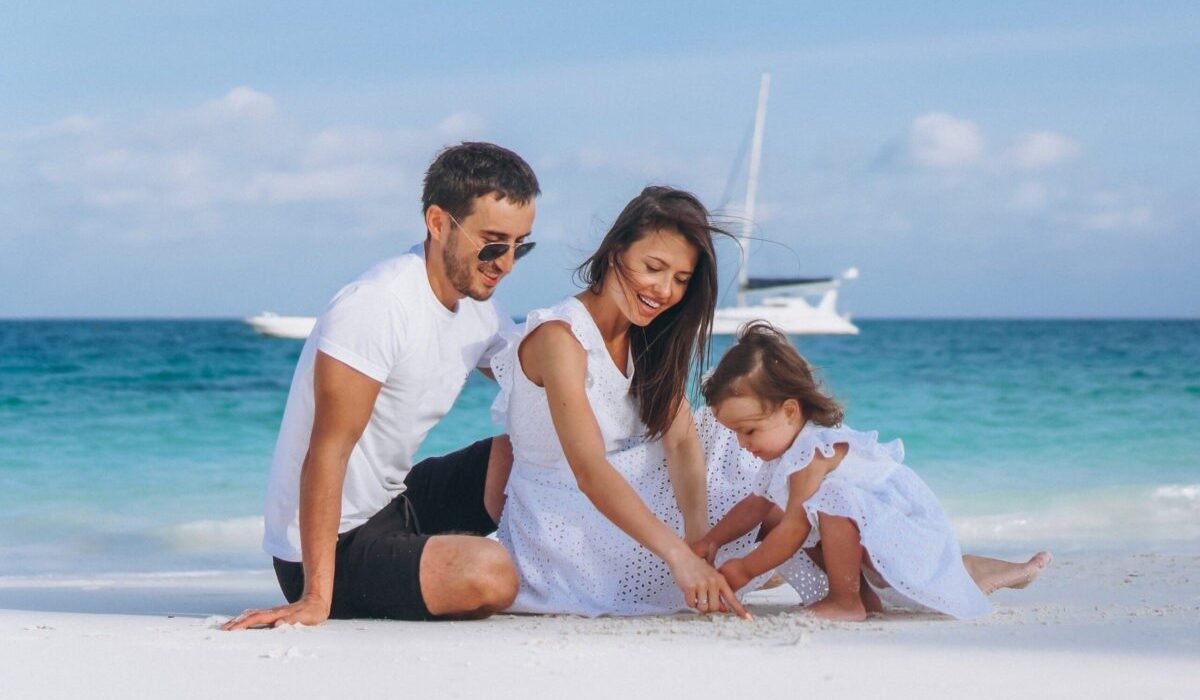 Young family with little daugher on a vacation by the ocean